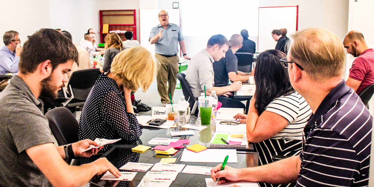 Photo of Jared Spool leading 24 workshop guests through our UX strategy workshop.